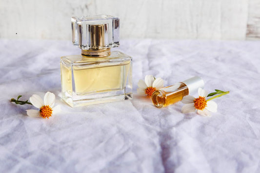 Travel-size and full-size perfume bottles with flowers, showcasing compact fragrance options for daily and vacation use
