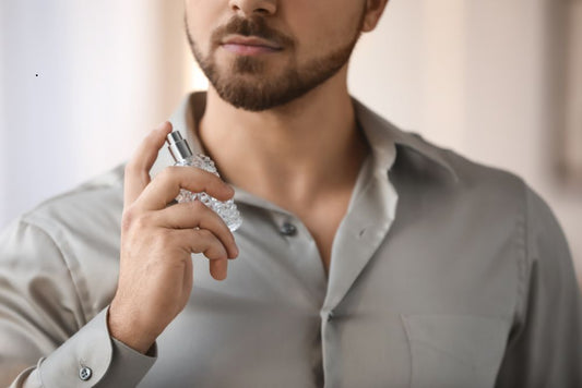 Man applying cologne to his neck, representing proper fragrance use and signs of cologne freshness and expiration.
