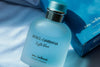 A bottle of Dolce & Gabbana Light Blue Eau Intense Pour Homme cologne, with its box visible in the background.