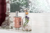 Vanity with bottles evoking YSL Libre Intense and Phlur Golden Rule
