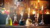 Vintage perfume bottles with Candles in a warm incense-inspired setting